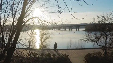 4K Sunset time lapse over the wide river Dnieper in Kiev through trees Stock Footage 104707669