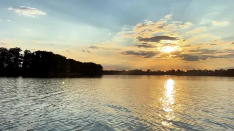 4K Sunset Water Trails Behind Boat on Serene Lake Stock Footage 282277823