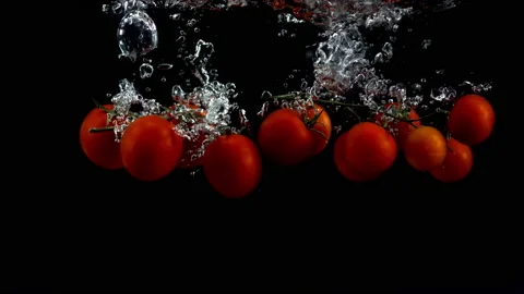 4K Super 1000 FPS Super Slow-Mo Of Cherry Tomatoes Falling Into Water Tank Stock Footage 151390206