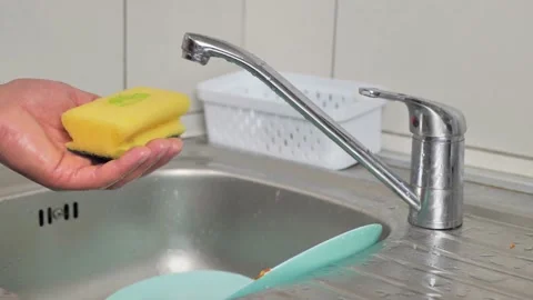 4K Super macro close up footage of yellow rotating sponge and pouring detergent Video stock 218978501