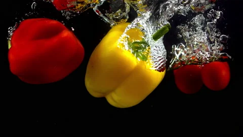 4K Super Slow-Mo Of Mixed Veggies Falling In Water Tank On Black Background Stock Footage 151534043