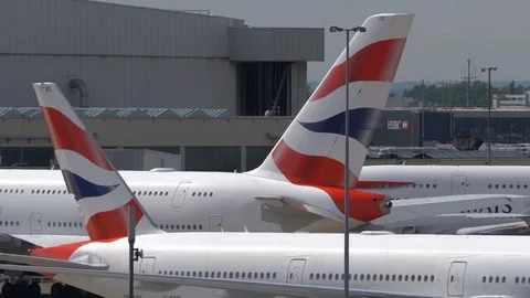 4k Super-telephoto view of multiple stationary planes pan to windsock Stock Footage 112066145