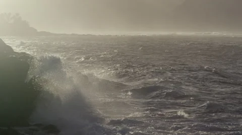 4K: Surf Hitting Rocks @ Dusk/Golden Light Slow Motion Pan Stock Footage 68577091