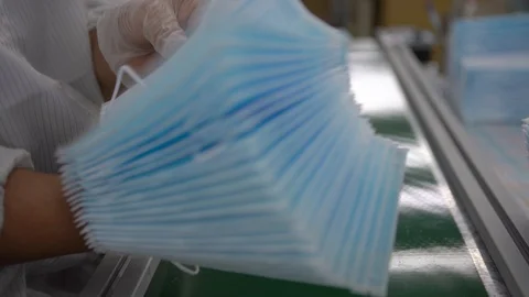 4K, Surgical masks in workshop for production medical clothing. Mask factory-Dan Stock Footage 128669641