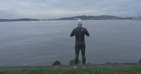 4k Swimmer puts on goggles. Seattle in background. Stock Footage 40274148