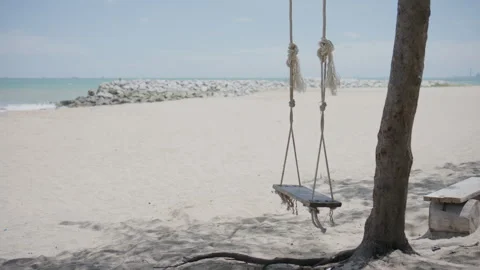 4K Swing moving slowly with a beach background Stock Footage 337711037