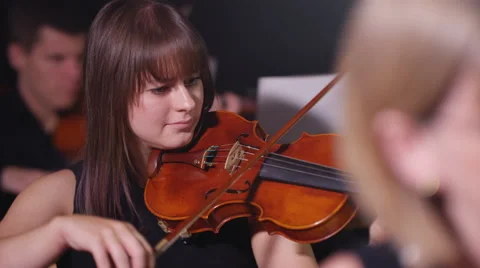 4K Symphony orchestra during a performance with focus on violinist Stock Footage 68665139