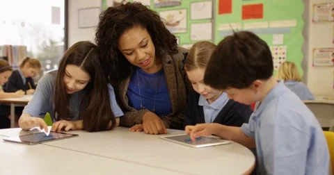 4k, Teacher and students with digital touchscreen tablet in a classroom Stock Footage