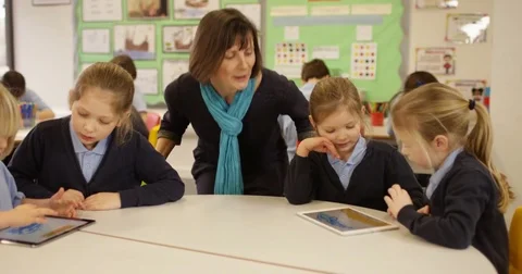 4k, Teacher and students with digital touchscreen tablet in a classroom Stock Footage