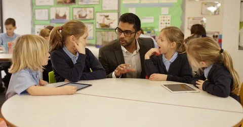 4k, Teacher and students with digital touchscreen tablet in a classroom Stock Footage