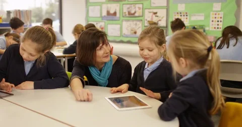 4k, Teacher and students with digital touchscreen tablet in a classroom Stock Footage