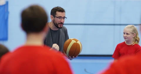 4k, Teacher having a team talk with the basketball team at a school court inside Stock Footage 68164971