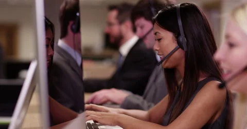 4k, A team of call centre executives wearing headset busy on a phone. Video stock 61532040