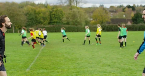 4K Team coaches shake hands &amp; chat at beginning of youth soccer match Stock Footage 86292271