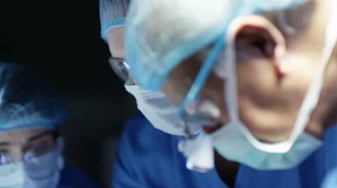 4K Team of surgeons in operating theater performing operation on a patient. 스톡 동영상 63042485