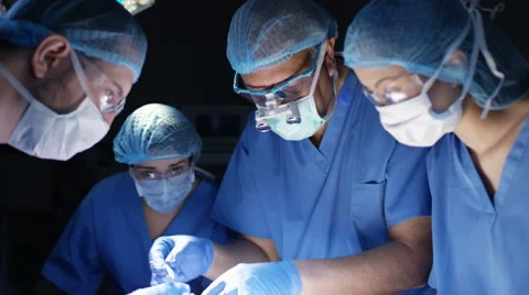 4K Team of surgeons in operating theater performing operation on a patient. Stock Footage