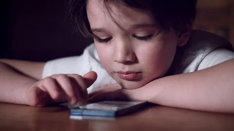 4K Tech-Addicted Child Looking in Smartphone Video stock 86209769