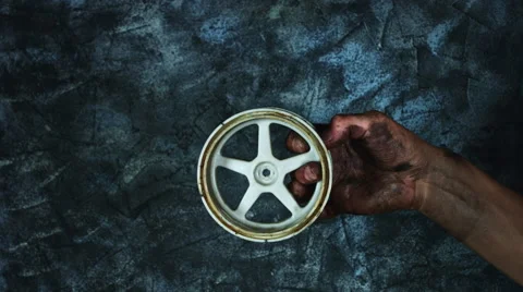 4k Technical Composition of Dirty Mechanic Hands Holding Wheel Stock Footage 66689161