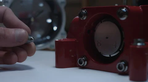 4k technical composition of a human hand placing a bolt in a handmade clock Video stock 64765339