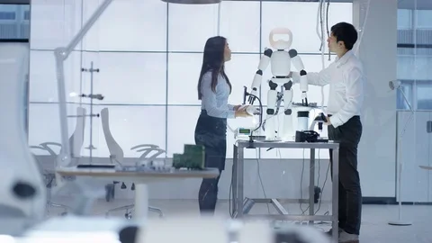 4K Technical engineers working together collaborating on project to build robot Stock Footage 71215242