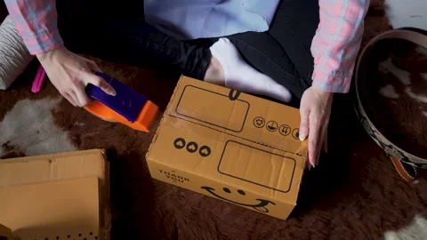 4K, Technician who is packing things into a brown rectangular box, Using Stock Footage 238967386