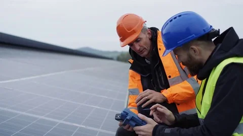 4K Technicians checking the panels at solar energy installation Stock Footage 72623502