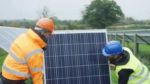 4K Technicians working at solar energy plant replacing a panel during inspection Stock Footage 69995487