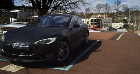 4k Tesla Model S parked outside traffic in background Stock Footage 137614186