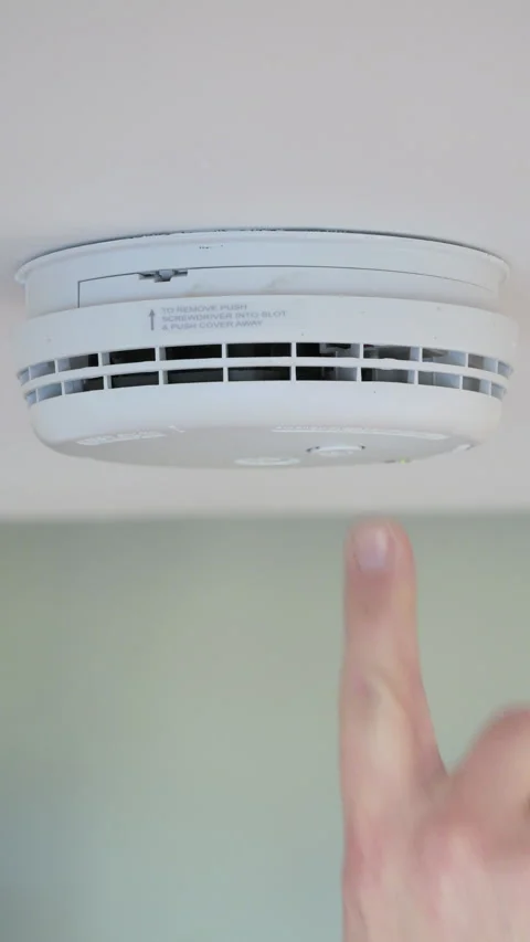 4K: Testing a smoke alarm in a house. Pushing the button. Vertical. Stock Footage 326778466