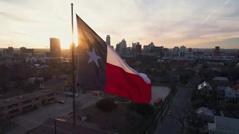 4K Texas Flag Aerial at Sunset with Downtown Austin in Back Stock Footage