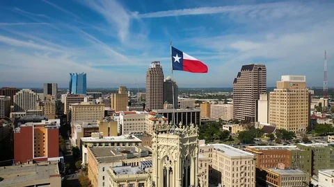 4K Texas Flag Flying Over San Antonio in Background Drone Orbit Dolly Right Stock Footage 119716637
