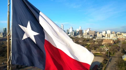 4K Texas Flag Flys Over State Capital Austin Texas Drone Footage Video stock 124077714