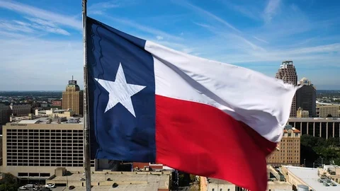 4K Texas Flag Over San Antonio Skyline Aerial Drone Static Texas Landscape Stock Footage 119726017
