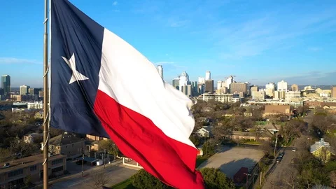 4K Texas Flag Texas State Flag Austin Tx Skyline Slow Motion Drone Aerial Video stock 124077479