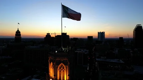 4K Texas Flag Waving Over San Antonio Drone Aerial Orbit Sunset Stock Footage 119777718