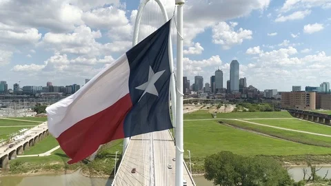 4K Texas State Flag Dallas Skyline Aerial Slow Motion Stock Footage