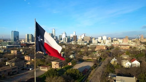 4K Texas State Flag Reveal Reverse Drone Footage Austin Texas Skyline Background Stock Footage 124077461