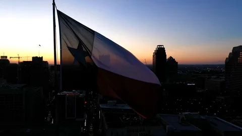 4K Texas State Flag San Antonio Skyline at Sunset Twilight Sunrise Dawn Dusk Stock Footage 119753471