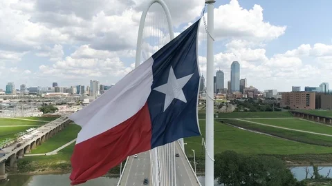 4K Texas State Flag Slow Motion Dallas Skyline Aerial Margaret Hunt Hill Bridge Stock Footage 95825270
