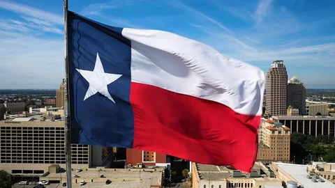 4K Texas State Flag Texas Flag Over San Antonio Drone Aerial Afternoon Blue Sky Stock Footage 119726010
