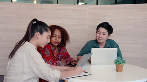 4K, Three high school students are sitting together helping each other do g.. Stock Footage 236746175