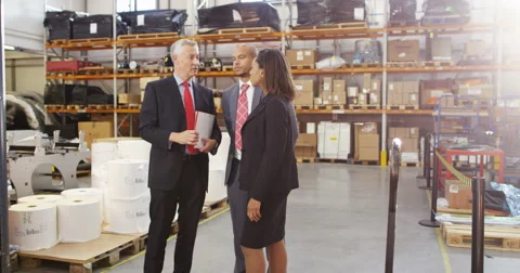 4k, Three warehouse workers discussing logistics of their business in warehouse Stock Footage 68958969
