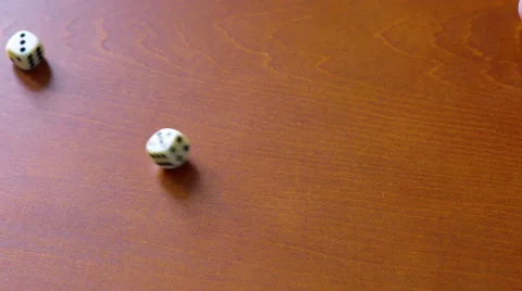 4K throwing white dice from leather cup on brown table, picking up with hand Stock Footage 51130132