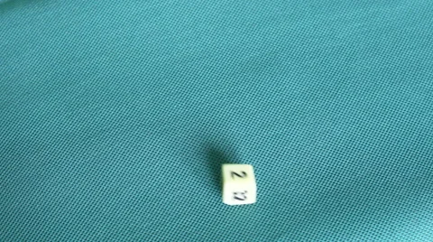 4K throwing a white doubling dice on a green table, getting a two Stock Footage 51357612