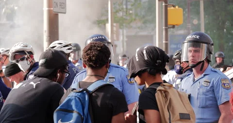 4K TIGHT SHOT OF BLACK PROTESTERS TALKING TO WHITE POLICE Stock Footage 131453390