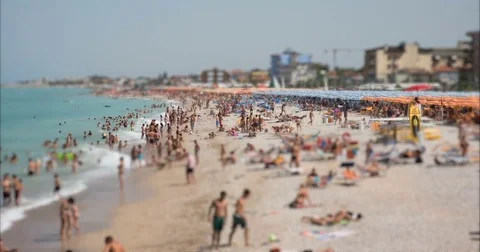 4K Tilt Shift / time-lapse of a busy beach in August. Stock Footage 83951294