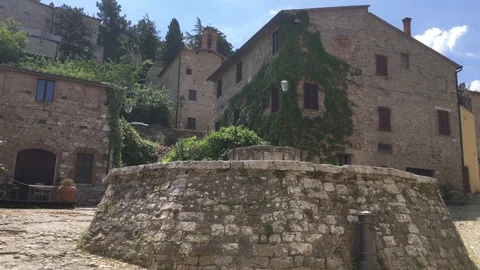 4K tilt up of the square with the big well in the medieval village Stock-Footage 80149669