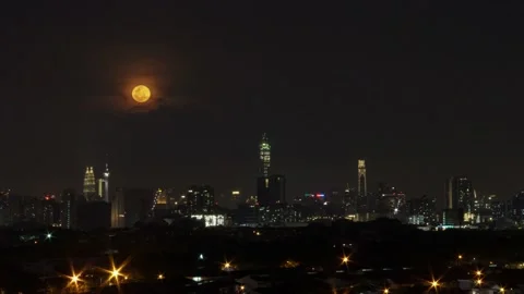 4K Time lapse 2020 last full moon rise behind Kuala Lumpur skyscrapers Stock Footage 145885719
