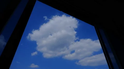 4K Time lapse of blue sky with white clouds, looking from window with curtains Stock Footage 131447310