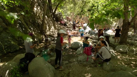 4K Time lapse blurred motion of resting visitors in Eaton Falls canyon river Stock Footage 147998224